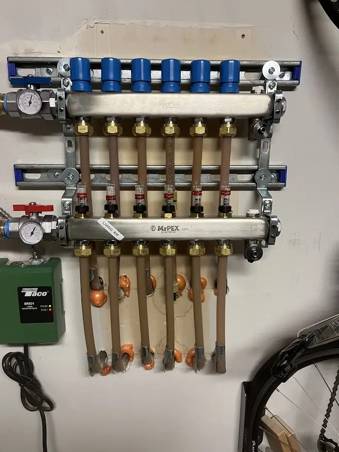 Plumber performing Water Heater Repair at a residential property in Romeo